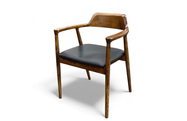 Wooden chair with black cushion on a white background