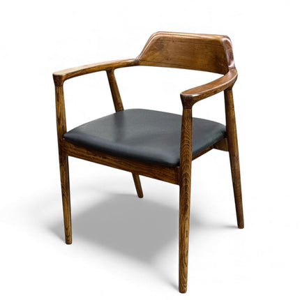 Wooden chair with black cushion on a white background